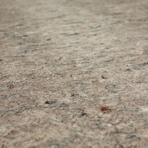 Close-up of non slip rug pad with felt texture for hardwood, tile, and carpet floors, 6 by 9 feet, made in USA.