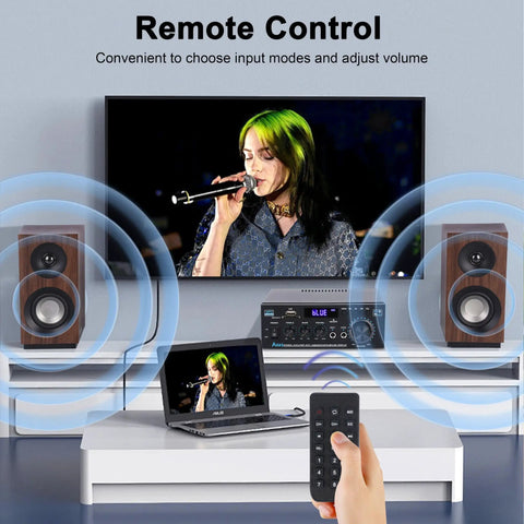 Living room setup with Dope Bluetooth 5.0 Stereo Amplifier 400W 2 Channel, remote control, speakers, laptop, and TV.