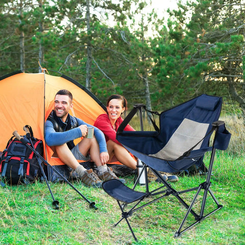 Campers beside a tent with Detachable And Retractable Footrest Hammock Camping Chair With Cozy Head Pillow in green setting.