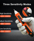 Non Contact Voltage Tester That Is Super Handy With Buzzer Alarm And Bright Flashlight For Home And Jobsite, 3 Voltage Ranges 12V 48V 70V To 1000V, Live And Null Wire Finder, NCV Detector, Wire Breakpoint Finder, Orange, shown in gloved hand