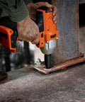 Person using power tool with Screw Extractor Set 10 Piece Hex Head Easy Outs For Stripped Fasteners MultiSpline EZ Out Kit installed on metal beam.
