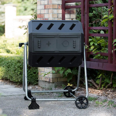 Dual Chamber Tumbling Compost Bin With Wheels, 37 Gallon Outdoor Garden Recycler, Elevated Rotating Bin in garden setting
