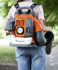 Child wearing backpack-style 150BT Inspired Toy Bubble Leaf Blower for Kids, Realistic Air Blast With Lights, producing bubbles