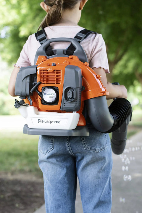 Child wearing backpack-style 150BT Inspired Toy Bubble Leaf Blower for Kids, Realistic Air Blast With Lights, producing bubbles