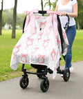 Pink Bow 2-In-1 Muslin Baby Car Seat Cover on stroller, showcased outdoors, 100% organic muslin, lightweight, breathable nursing shield.