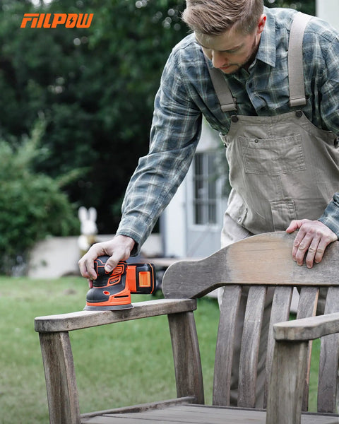 Man using Cordless Random Orbital Sander 20V Brushless With 2.0Ah Battery Micro-Filter Cyclonic Dust Box on outdoor wooden chair