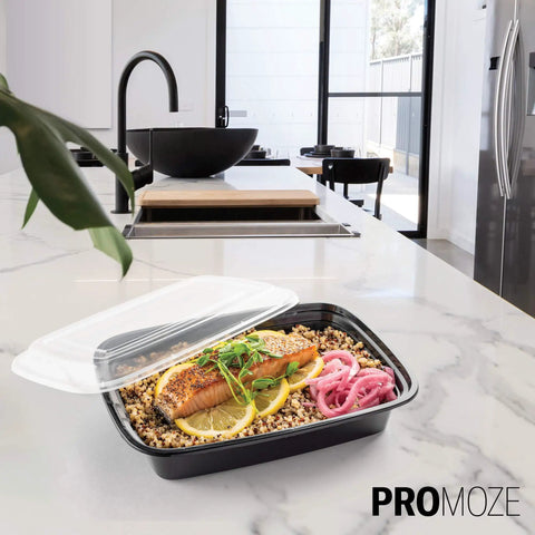50 Pack Meal Prep Containers With Lids 28 Oz One Compartment To Go Bento Boxes with food in a kitchen on a marble counter