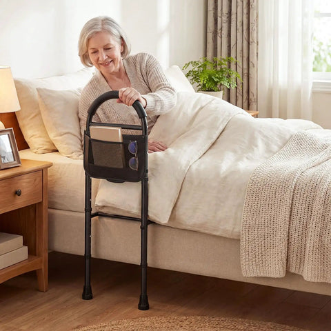 Woman using Bed Rail Guard For Elderly Safety, Adjustable Height Bed Side Assist Bar With Non-Slip Handle by bed.