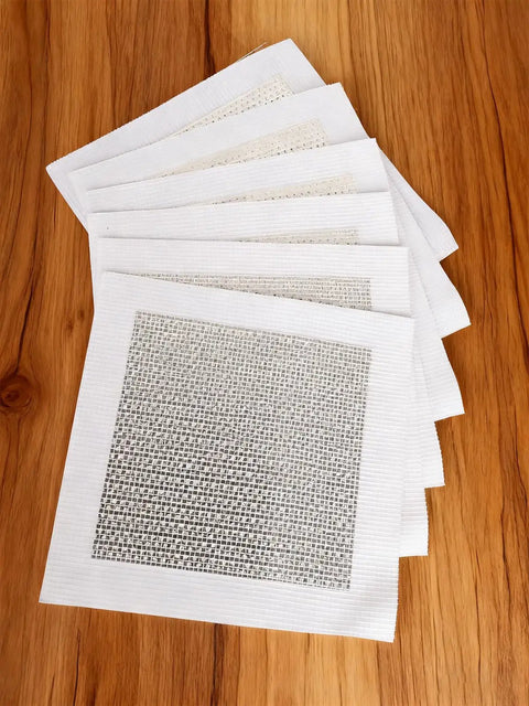 Pack of six Self Adhesive Drywall Patch 4x4 Inch Aluminum Mesh Patch Kit on wooden surface