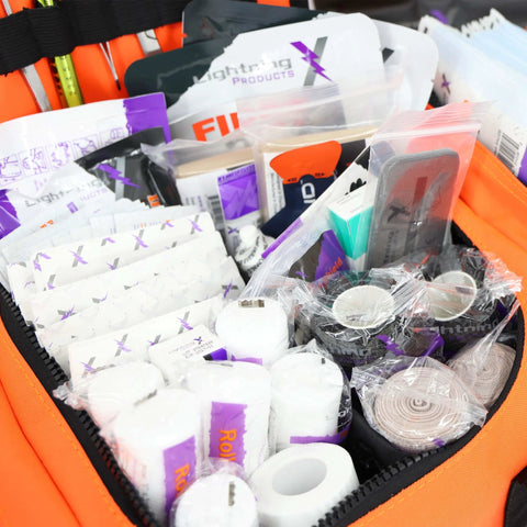 Lightning X Value Compact Medic First Responder trauma bag, orange, opened to reveal basic fill kit and assorted first-aid supplies