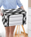 Woman holding Totally Slick Foldable Storage Bin With Clear Vinyl Window And Reinforced Steel Frame Dual Zippered Openings For Hassle Free Access Checkered Pattern Collapsible Closet Organizing Crate.
