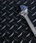 Commercial Grade Vinyl Diamond Plate Floor Mat Knockout Traction with heavy duty wrench on surface, 36x20 ft.