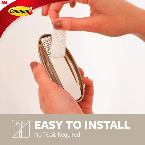 Person installing Large Timeless Wall Hook Holds Up To Five Pounds With Two Strips Brushed Nickel Finish Damage Free