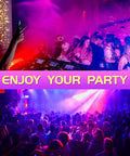 Party scene with DJ, crowd dancing under colorful lights, using 2 Pack 100W IP66 Waterproof Black Light Flood Lights for neon effects.