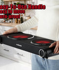 Person holding Dual Infrared 1800W Hot Plate Portable Electric Stove with glass cooktop in a kitchen.