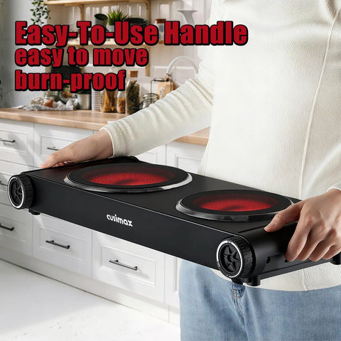 Person holding Dual Infrared 1800W Hot Plate Portable Electric Stove with glass cooktop in a kitchen.
