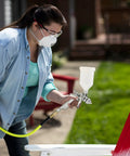 Person using HVLP Gravity Feed Spray Gun For Auto And Home Garage Projects, Furniture, And Equipment Painting With 600 mL Cup