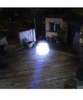 Two Pack LED Tactical Flashlights Water Resistant Military Grade 2000 Lumens lighting up outdoor wooden deck at night