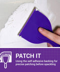 Using a purple spatula on a wall with 6 Inch By 6 Inch Flexible Self Adhesive Wall Patch Three Pack For Patching Holes Cracks And Corners