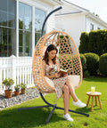 Hanging Egg Chair With Cushions And Stand For Patio Garden Or Balcony Chill Outdoor Swing Chair Cozy Rattan Lounge Seat For Indoor Or Outdoor Use 350 Lbs Capacity Yellow shown in use on a lawn.