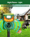 Solar Powered Ultrasonic Animal Repeller With Pir Motion Sensor, Yard Deterrent For Cats, Dogs, Birds, Rabbits, Skunks, Squirrels And Deer, 180 Degree Coverage Up To 26 Feet, Flaming Eye Alarm, Weatherproof Outdoor Pest Deterrent. Solar outdoor pest repeller on stake in a lawn