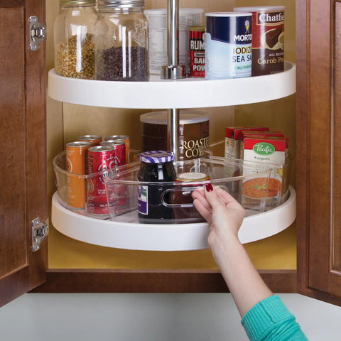 Hand reaches for jar in Clear Plastic Lazy Susan Cabinet Storage Bins Set Of 4 Quarter Wedge Containers for kitchen storage.