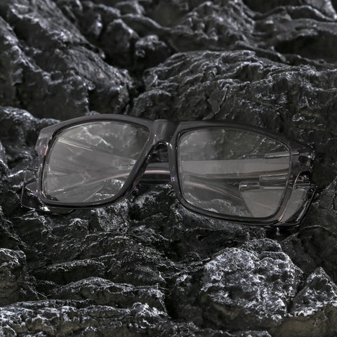 Real Deal Job Site Safety Glasses With Smash Proof Polycarbonate Lenses laying on dark rocky surface, showcasing the anti-fog design.