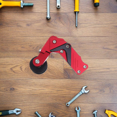 Red Universal Aluminum Motorcycle Chain Tensioner Kit With Auto Adjuster Roller For Dirt Bike Motocross And ATV Keeps Your Chain Smooth Like Butter While Cutting Down On Wear And Tear For Less Maintenance hassle Free Riding. Red aluminum chain tensioner with roller on wood surface.