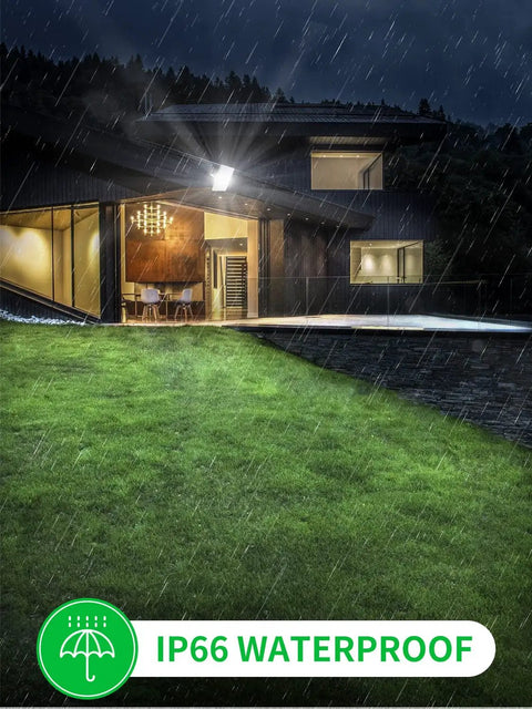 Beastly Bright 300W LED Flood Light illuminating house exterior and lawn in rain, showcasing IP66 waterproof feature