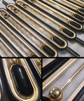 Built Tough Adjustable Stair Railing Spindles And Deck Balusters Made From Wrought Iron With Rust Proof Coating Great For Interior Steps Exterior Landings Featuring Flexible Mounting Brackets And Crisp Black Gold Modern Columns 10 Pack close-up of black and gold spindles with pre-drilled bases.