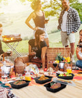 Group enjoying picnic with 50 Pack 32oz Meal Prep Containers With Leakproof Lids BPA-Free Plastic Food Storage on blanket.