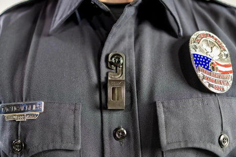 Close-up of Secure Mic Klip Two Way Radio Microphone Clip for First Responders and Uniforms on police shirt epaulet.