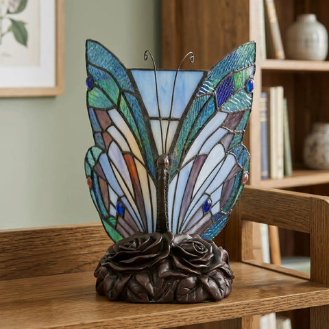 Handcrafted Stained Glass Butterfly Lamp With LED Bulb Included, Desk And Table Light For Bedroom Or Living Space, Colorful Vintage Vibe Decor, Beautiful Glass Art Accent shown on a wooden table with carved bronze rose base.