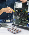 Person using screwdriver to install fan inside desktop PC, with Hassle Free 450 Piece Computer Screw Kit For PC Building And Repairing on the desk.