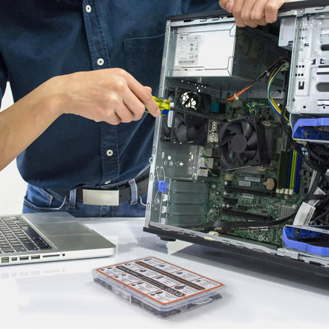 Person using screwdriver to install fan inside desktop PC, with Hassle Free 450 Piece Computer Screw Kit For PC Building And Repairing on the desk.