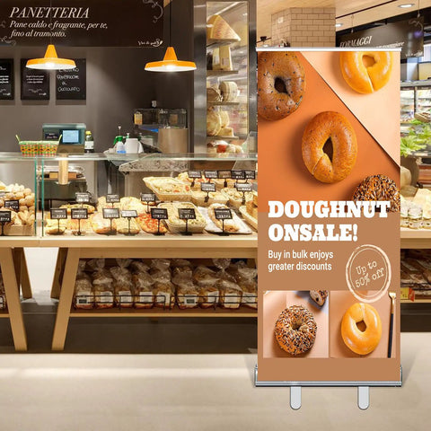 Bakery setting with a custom retractable banner with aluminum stand promoting doughnut sale, 33x81 inches, in full color design.