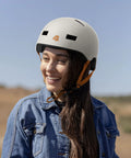 Woman wearing Dakota Adult Bike And Skate Helmet For Daily Commutes And All Action Sports, Matte Eggshell Finish, Impact Resistant