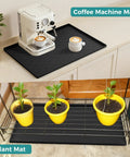 34 By 22 Inch Waterproof Silicone Mat used beneath a coffee machine and plant pots in light grey for multiple purposes.