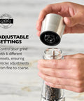 Hands adjusting Pepper Grinder With Adjustable Six Level Grind, Stainless Steel Mill, Gourmet Precision Mechanism, Keeps Pepper Fresh And Aroma Locked, Perfect Kitchen Essential For Cooks And Home Chefs.