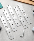 Slatwall Metal Plate Mount Backplate Adapter 10 Pack for Heavy Duty Slatwall Displays with Three Pre Drilled Holes on table