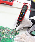 Technician using UT116C Pro Smart SMD Tester with Rotating LCD and Tweezers on circuit board