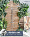 Outdoor Shower System in SUS304 Brushed Nickel on wooden wall with plants, 8 Inch Rainfall Head, Handheld Spray, Tub Spout, Patio Use