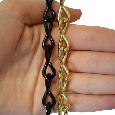 Hand holding black and gold chains, unrelated to Solid Steel Pendant Chain, 10 Gauge, 164-Foot Reel, Polished Nickel Finish.