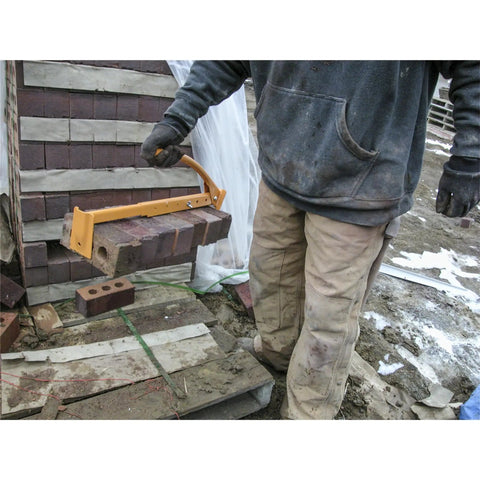 Worker using Beefy QLT Brick Tongs With Metal Handle or Soft Grip, adjustable brick carrier claw for lifting masonry on site.