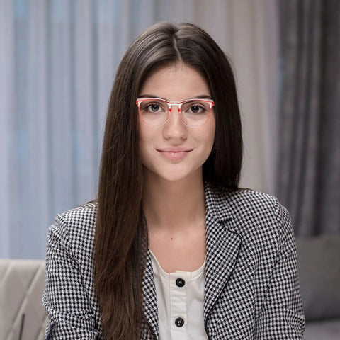 Young woman wearing red-frame glasses, sitting indoors. Not related to 4 Pack Safety Glasses Anti Fog Clear Goggles With Side Shields.