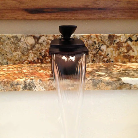 Waterfall Lav Faucet With Single Lever, Oil Rubbed Bronze Finish, water flowing over marble surface