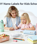 Two children labeling school items with D110 Upgraded Mini Label Maker With Tape, Pocket Size Bluetooth Thermal Printer.
