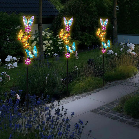 Outdoor Solar Butterfly Stake Lights Waterproof Garden Pathway Decor With Lit Up Soft Yellow Glow 2 Pack in yard at night