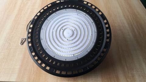 240W UFO LED High Bay Light 6500K Hella Bright for warehouse, die cast aluminum, top view on wooden surface.