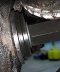 Close-up of Front Wheel Drive Bearing Press Kit 23 Piece Bearing Puller Set installed on a car's wheel hub, showing sliding screws.
